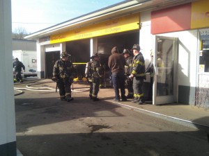 Firefighters extinguish car fire inside Boston Ave. Shell--Photo by Johnny Fresco