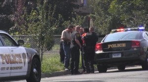 Police check to make sure intended victim was not hit by gunfire.