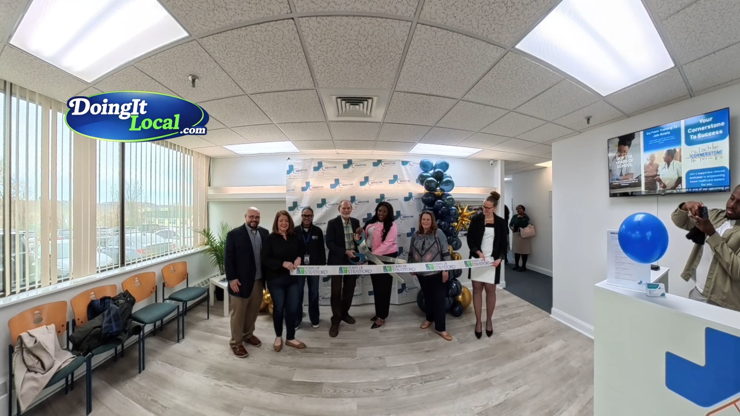 Ribbon cutting ceremony at Cornerstone Medical Training Center’s new Stratford location, with founders, local officials, and attendees gathered outside the facility celebrating the opening.